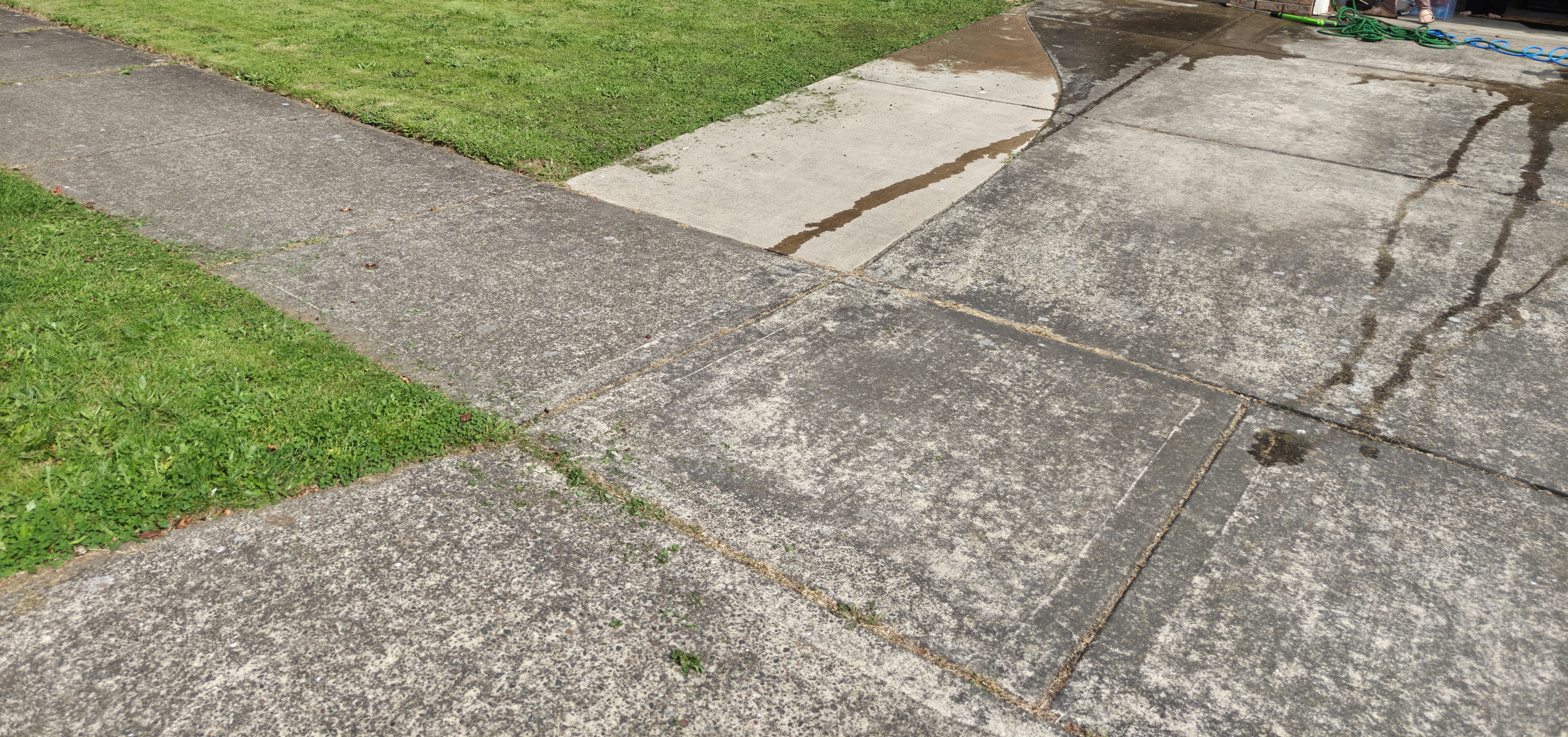 Driveway before pressure washing — dirty, stained concrete